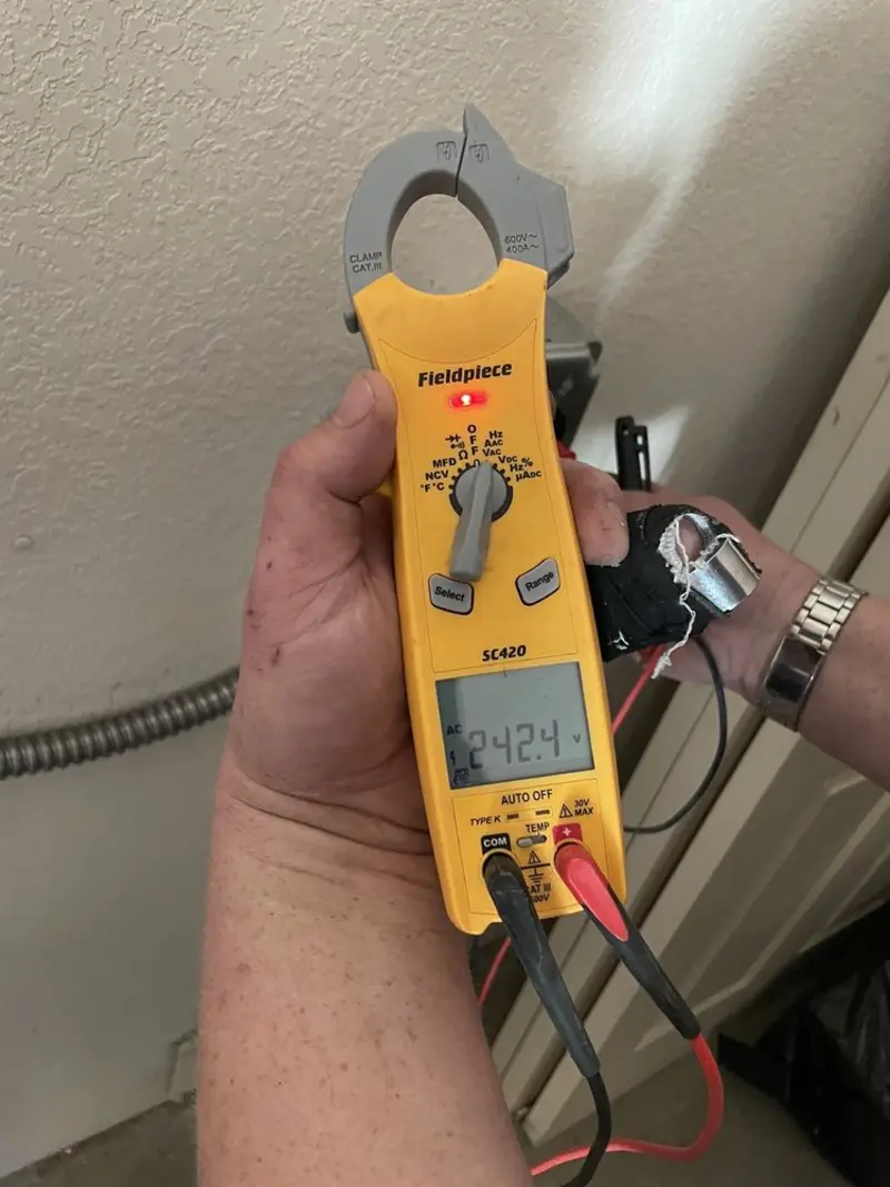 Voltage testing with clamp meter during Whole House Surge Protector in West Plains